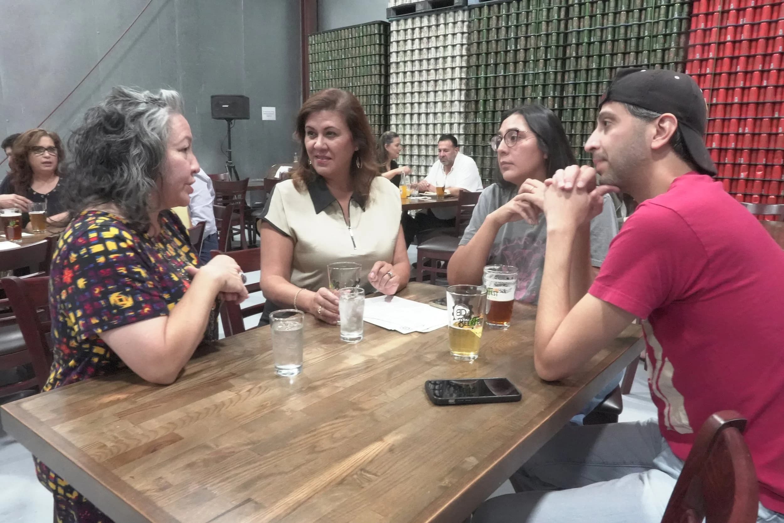 Attendees in conversation around a table at a Startup Week session.